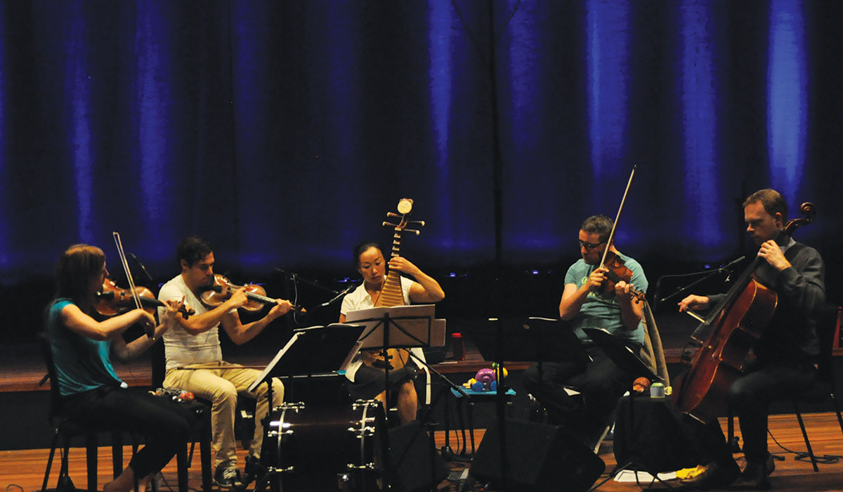 Liu Fang (center) plays the pipa during a rehearsal with fellow musicians.