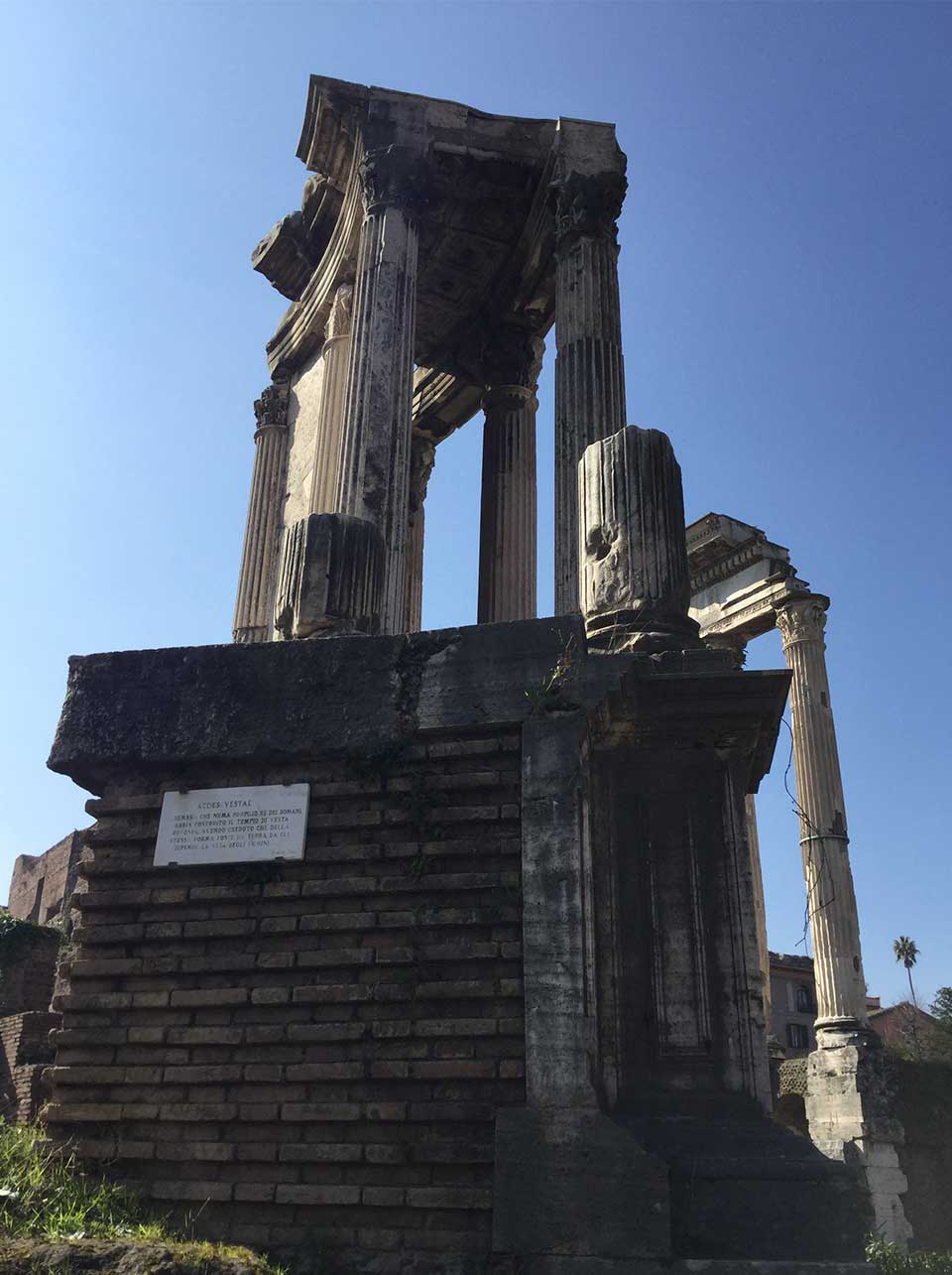 A photograph shot from below of a crumbling arch