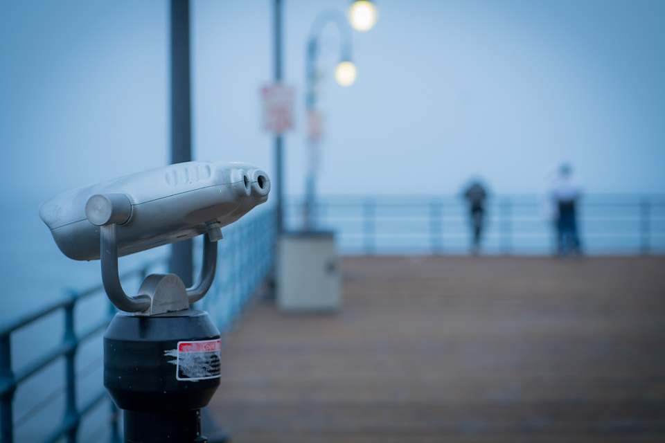 A photograph of pier binoculars, shrouded in fog