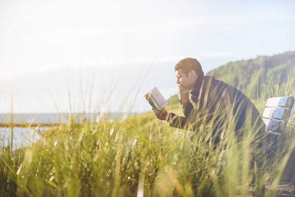 Man reading on a bench