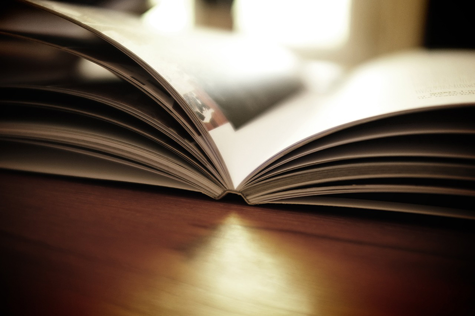 Open book on a desk in sunlight