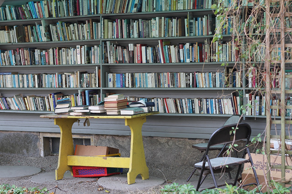 Books on a library shelf outside