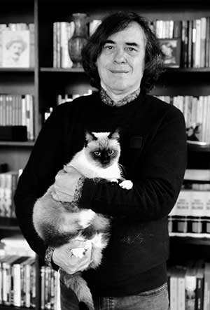 A photograph of Mircea Cartarescu holding a cat