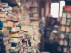 Stacks of books in a room with a window