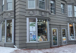 The exterior of a bookstore, which occupy the corner lot on a urban building