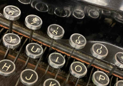 A close-up photograph of the punctuation/number row of a manual typewriter