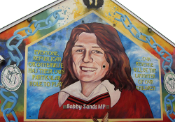 A mural with a painting of Bobby Sands. The text reads “Everyone. Republican or otherwise has their own particular role to play...our revenge will be the laughter of our children.” 